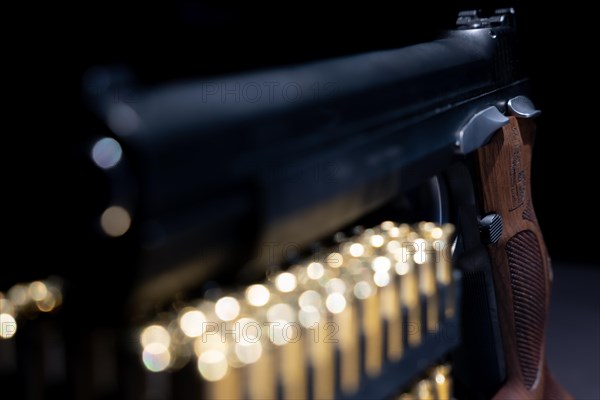 Elegant Semiautomatic 9mm Handgun with Swiss Helvetia Symbol Leaning on Bullet Ammunition in Switzerland