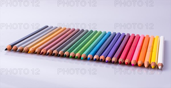 Color Pencils of Various colors placed on white background