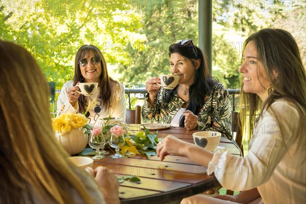 Group of happy friends sitting at a round table