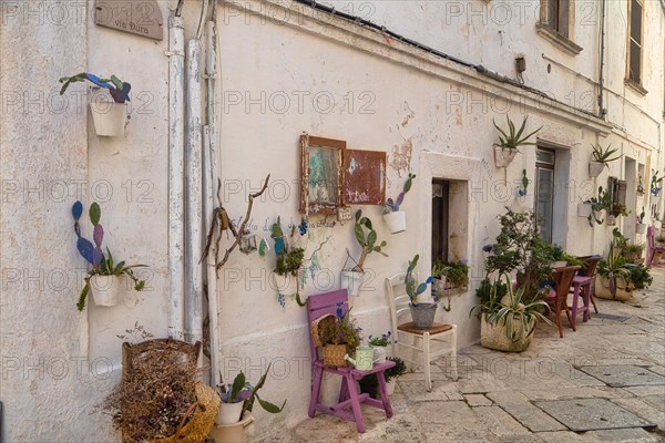 Chairs and floral decoration in the old town of Locorotondo