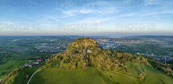 Aerial panorama of the volcanic cone Hohentwiel with the castle ruins illuminated by the evening sun