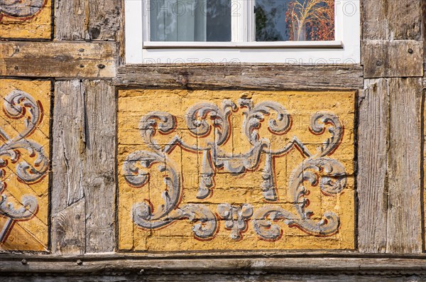 Frames with painted ornaments on one of the half-timbered houses typical of the World Heritage town on the Schlossberg