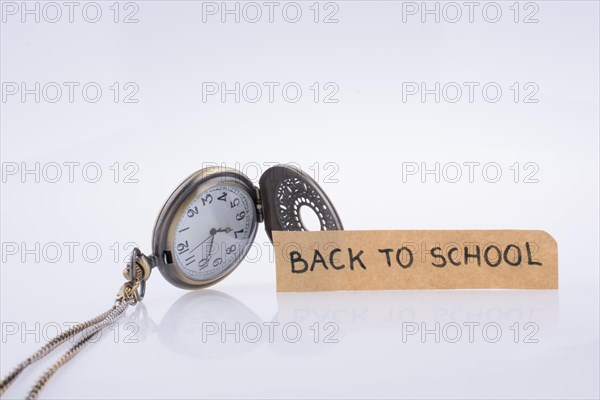 Back to school written title and a pocket watch