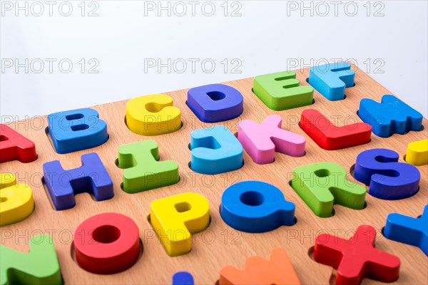 Colorful letter blocks on board on white background