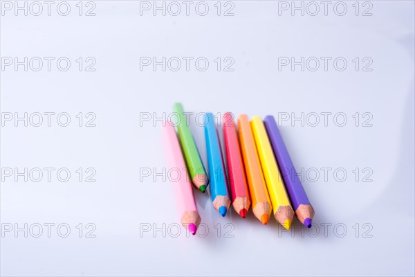 Color Pencils of Various colors placed on white background