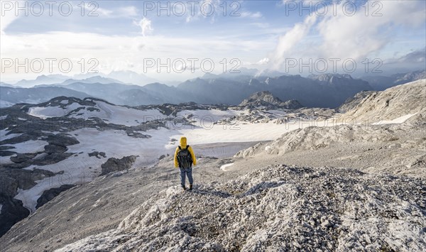 View of rocky plateau with glacier and remnants of snow