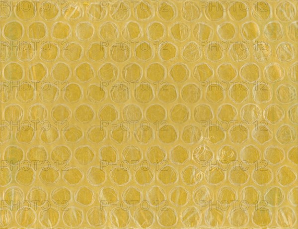 Yellow bubble wrap plastic and paper texture background