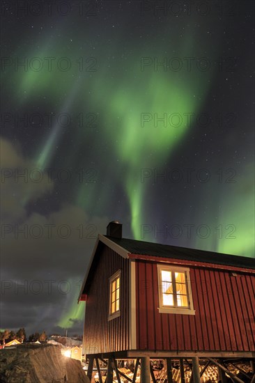 Northern Lights or Aurora Borealis over red rorbuer
