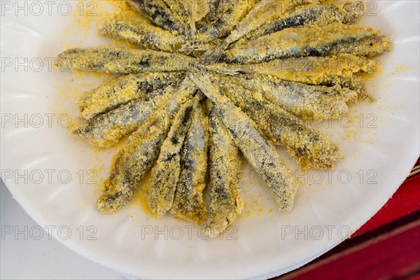 Plates with fried anchovies fish as seafood