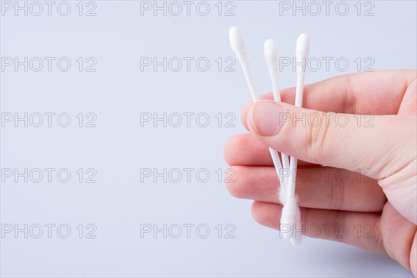 A few ear sticks in hand isolated on white background