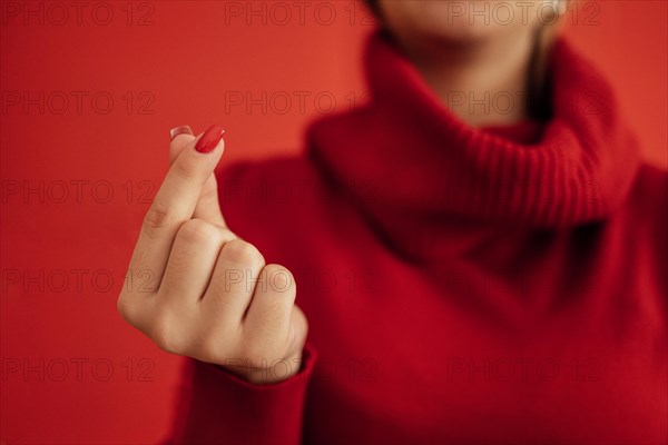 The Korean symbol for love is obvious. A woman's hand covers a heart. Place for text. Happy Valentine's day