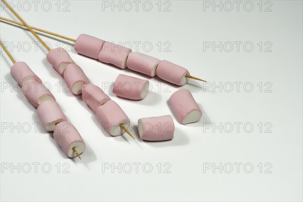 Close-up of marsmallow skewers isolated on white background with copy space