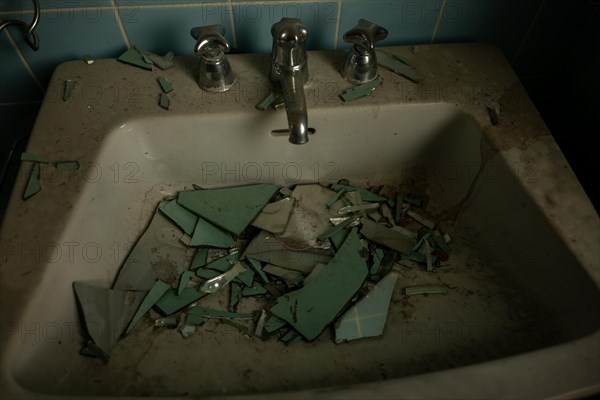 Abandoned House in Bathroom with Broken Mirror in Sink in Switzerland