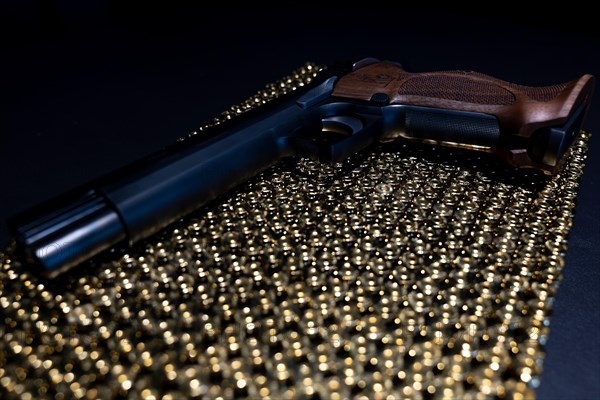 Elegant Semiautomatic 9mm Handgun with Swiss Helvetia Symbol Leaning on Bullet Ammunition in Switzerland