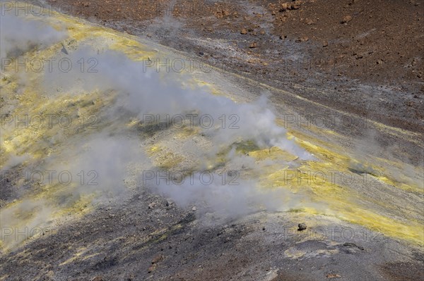 Smoking sulphur fumaroles at the crater rim