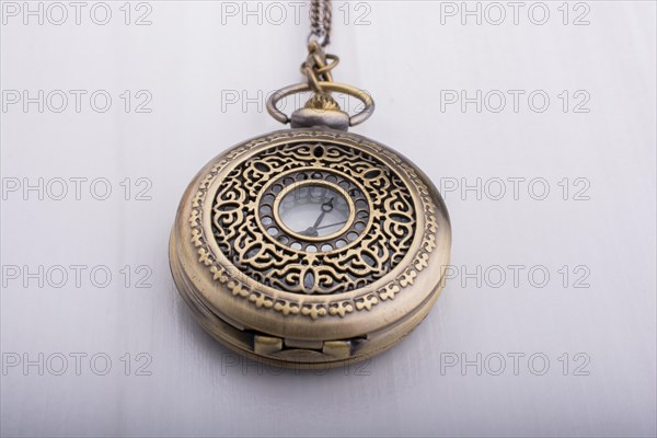 Retro style pocket watch on white background