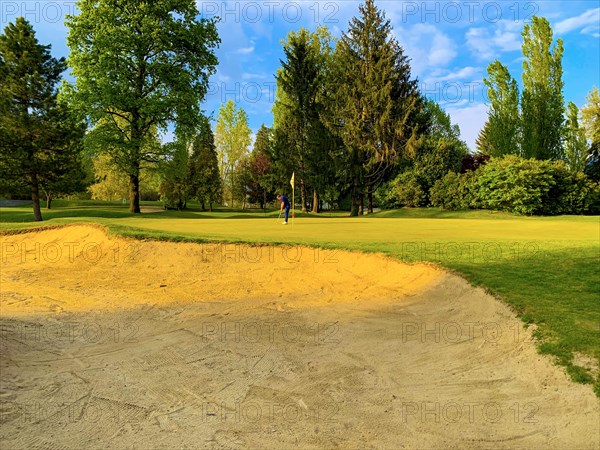 Golfer on Putting Green with Sunlight in Switzerland