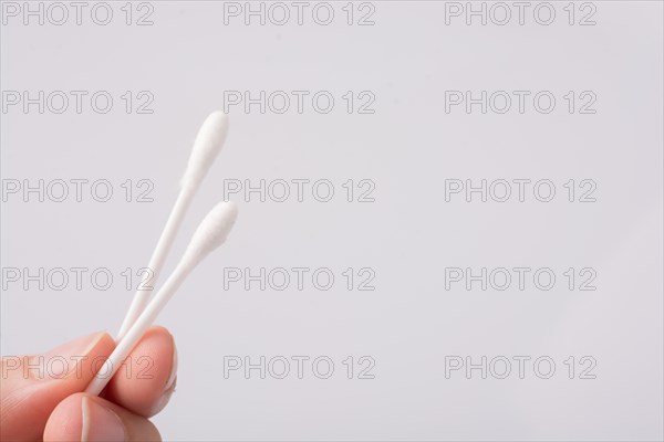 A few ear sticks in hand isolated on white background