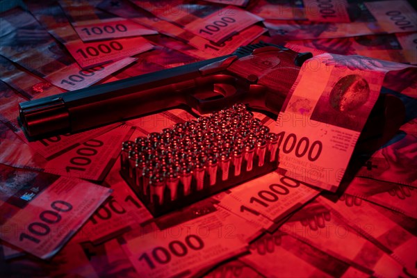 Elegant Semiautomatic 9mm Handgun with Swiss Helvetia Symbol Leaning on Swiss Franc 1000 Banknote and Bullet Ammunition in Switzerland