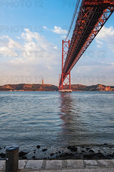 View from under of 25 de Abril Bridge famous tourist landmark over Tagus river