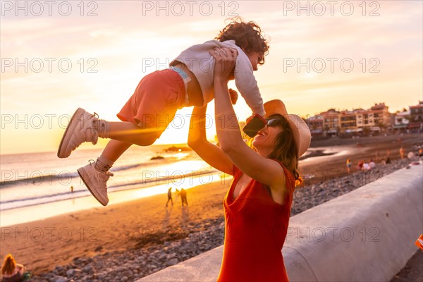 Mother and son at sunset on the beach of Valle Gran Rey in La Gomera