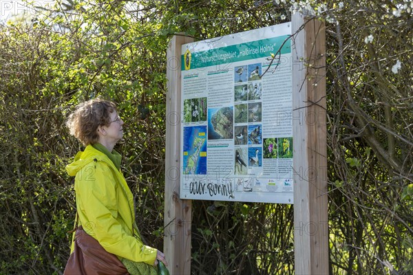 Woman looking at information board