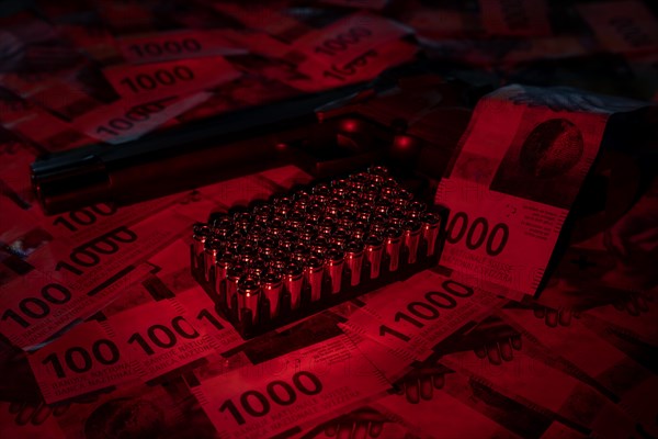 Elegant Semiautomatic 9mm Handgun Leaning on Swiss Franc 1000 Banknote and Bullet Ammunition in Switzerland