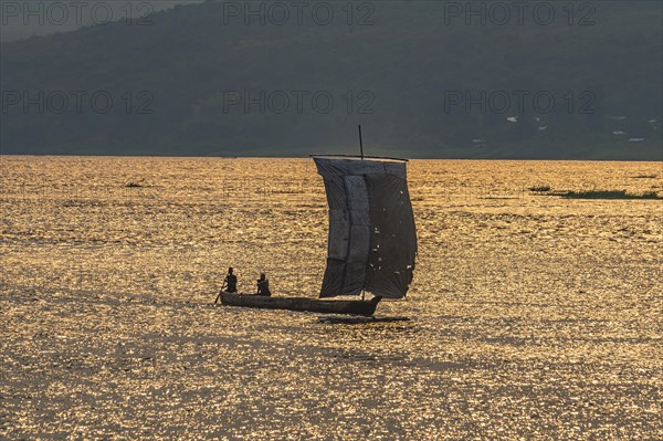 Traditional sailing boat on the Congo river at sunset