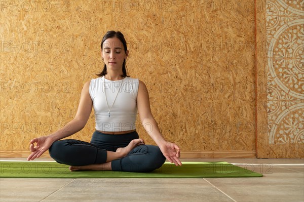 Woman meditating with her hands in gyan mudra position