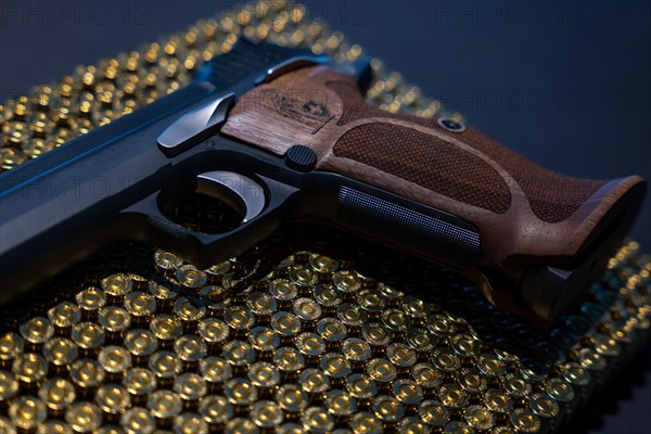 Elegant Semiautomatic 9mm Handgun with Swiss Helvetia Symbol Leaning on Bullet Ammunition in Switzerland