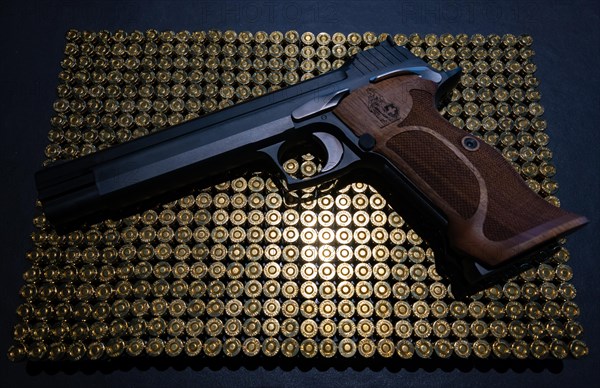 Elegant Semiautomatic 9mm Handgun with Swiss Helvetia Symbol Leaning on Bullet Ammunition in Switzerland