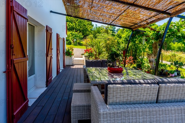 Summer house terrace. Terrace next to the vegetation of the garden in the shade of the sun