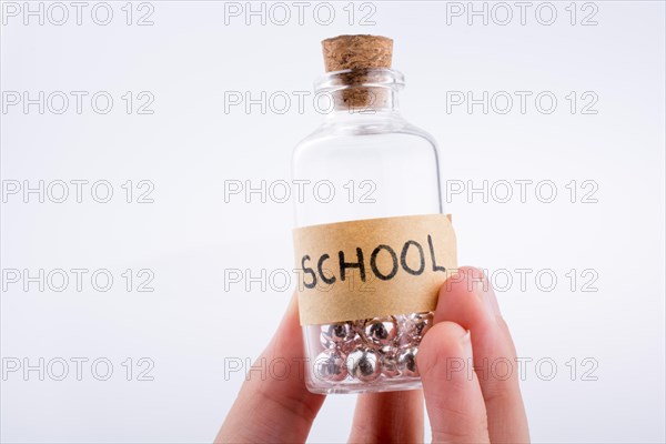 Little perfume glass bottle in hand on a white background