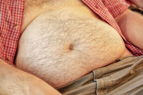 Naked and hairy belly of a middle-aged man