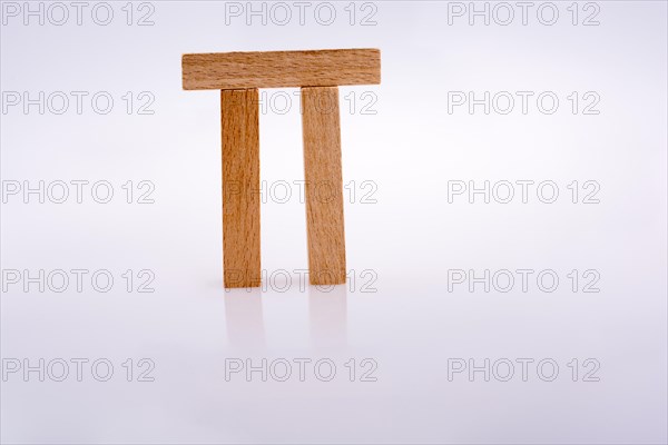 Wooden domino pieces positioned on white background