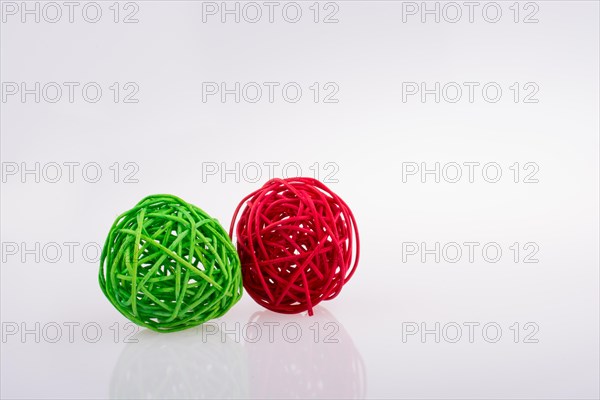 Red and green wooden balls on a white background