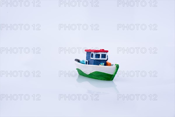 Little colorful model boat with windows on white background
