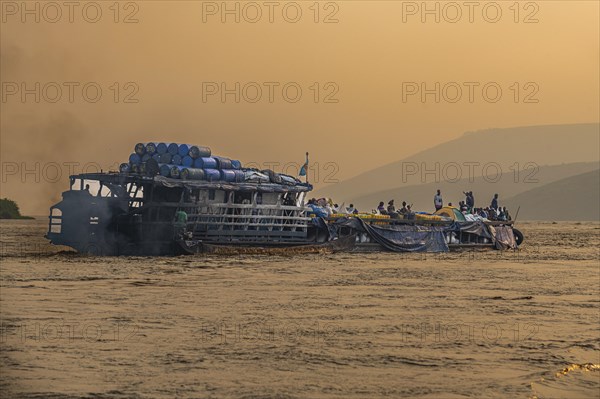 Overloaded riverboat on the Congo river