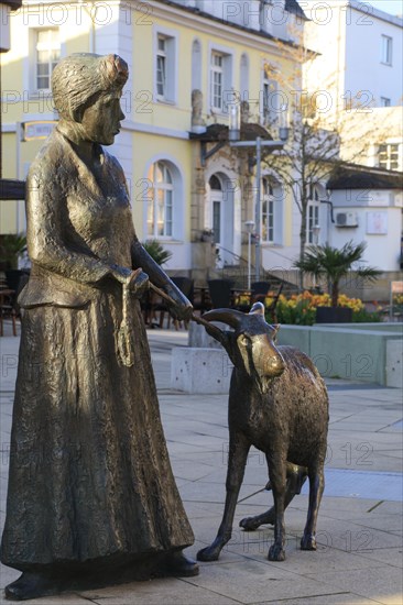 Statue of a woman with a goat on the main street