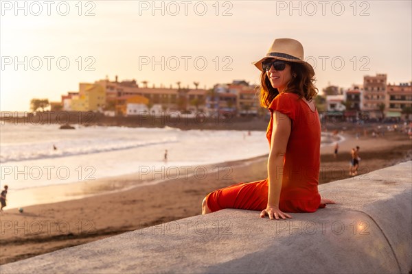 Tourist woman at sunset on vacation on the beach of Valle Gran Rey village on La Gomera