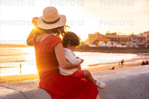 Mother and son at sunset on the beach of Valle Gran Rey village in La Gomera