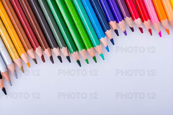 Color Pencils of Various colors placed on white background