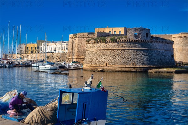 Fishermen in front of Castelo in the fishing port of Gallipoli