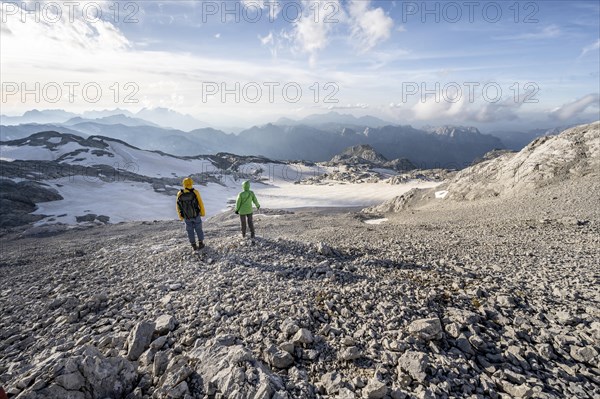 View of rocky plateau with glacier and remnants of snow