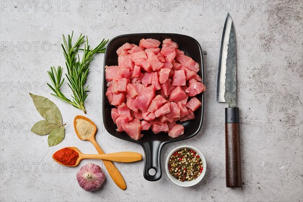 Top view of raw pork goulash in ceramic pan