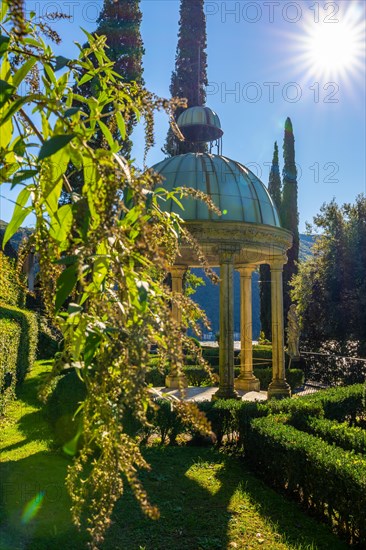 Dome with Column and Sunbeam in the Forest on the Mountain Side and Blue Clear Sky in Park Scherrer in Morcote