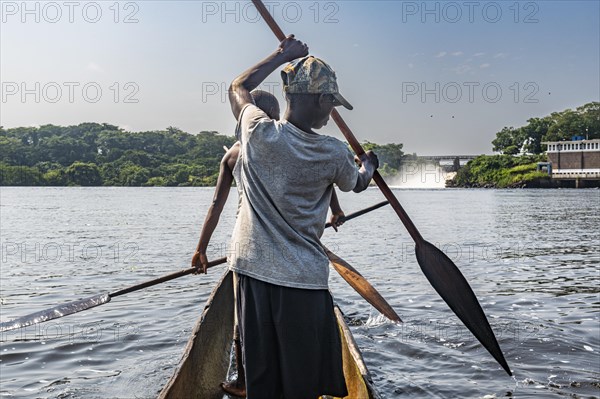 Fishermen fishing below the rapids on the Tshopo river