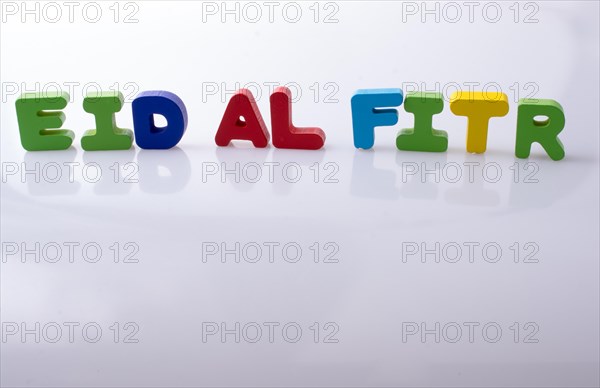 The word EID EL FITR written with colorful letter blocks