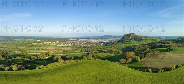 Aerial panorama of the volcanic cone Hohentwiel with the castle ruins illuminated by the evening sun