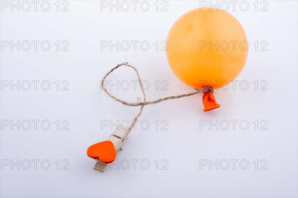 Clothespin with a heart tied to a balloon with a string